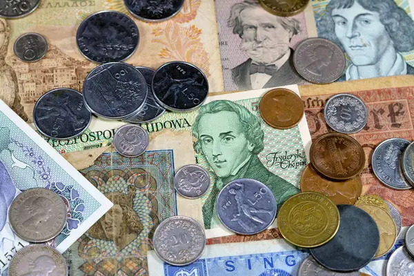 Old money currency of banknotes and coins from different countries of the world, world economy during different times concept, inflation, vintage retro old historic cash money notes and coins
