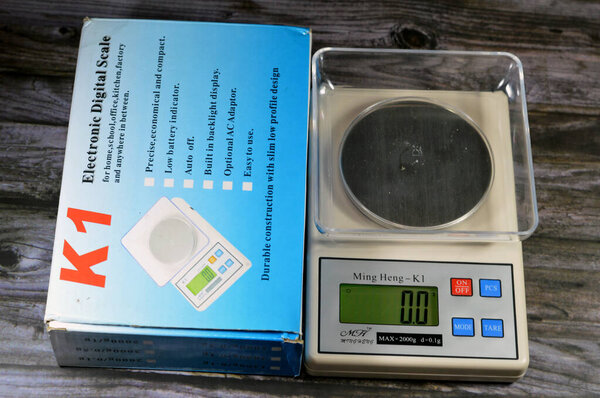 Cairo, Egypt, November 9 2023: A digital Ming Heng K1 scale in grams, electronic digital scale for home, school, office, kitchen and factory, precise weight, could be used for gold and precious metal
