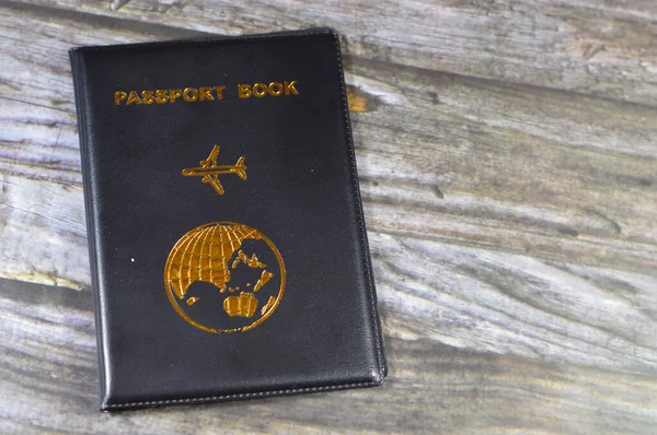 Black passport book with a plane and the globe earth on its cover, travel and tourism concept, universal passport book to protect the passport Identity, A passport is an official travel document ID