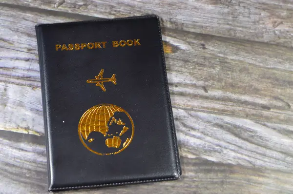 Black passport book with a plane and the globe earth on its cover, travel and tourism concept, universal passport book to protect the passport Identity, A passport is an official travel document ID