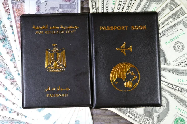 Egyptian passport black book, Translation of Arabic words (Arab republic of Egypt\'s passport) and Black passport book with Egyptian pounds and American dollars cash money banknotes, Travel concept