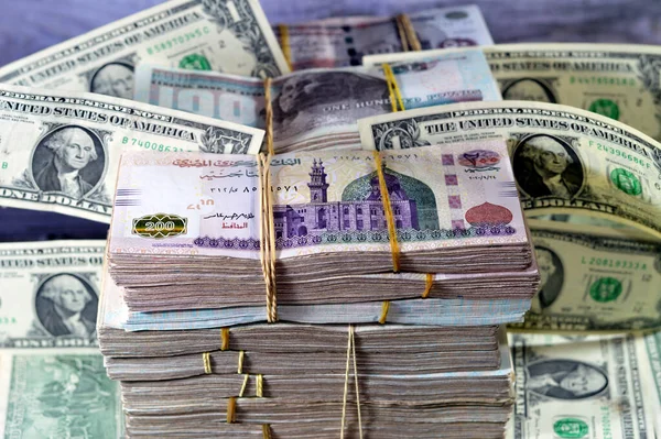 Stacks of Egypt money banknote bills EGP LE thousands of Pounds currency banknotes bill, Egyptian money exchange rate and USA American dollars banknotes bills, economy status, money concept, inflation