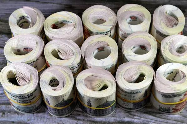 Piles and bundles rolls of Egypt money  thousands of Pounds currency banknotes bills of 200 EGP LE rolled up, Egyptian money exchange rate, money concept, inflation crisis, currency and investment