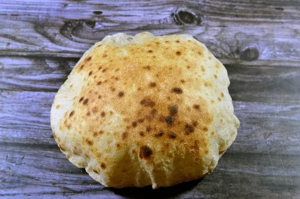 Traditional Egyptian flat bread with wheat bran and flour, regular Aish Baladi or Egypt bread baked in extremely hot ovens, it is the result of a mixture of wheat flour, yeast, salt and water