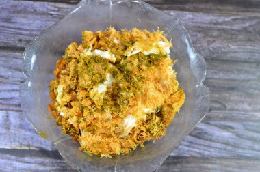 Mısır 'daki tatlı Koshary tarifinin üstüne sütlü puding, krem şanti, kızarmış Konafa ve filo fileto ile birlikte çok katmanlı pirinçten yapılma Pistachio sosu.