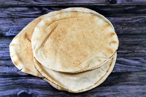 Traditional Shami flat bread with wheat and flour, small Aish Shamy or small pita bread baked in extremely hot ovens, it is the result of a mixture of wheat flour, yeast, salt and water