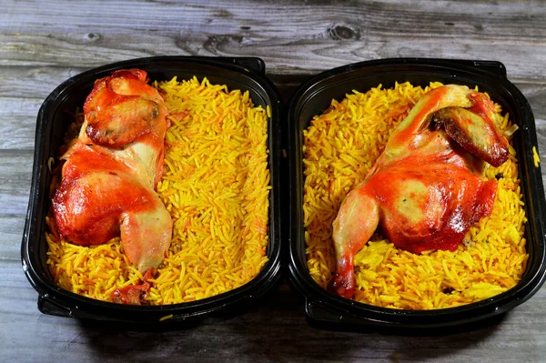 Chicken mandi kabsa with long basmati rice, usually served with tomato dakos sauce, green salad and tahini, Yemen recipe of Yemeni Mandi chicken and rice with spices and sauce, selective focus