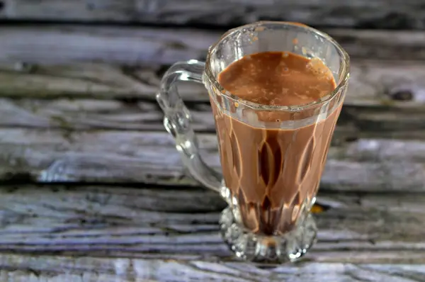 milk chocolate drink, a type of flavored milk made by mixing cocoa solids with milk (either dairy or plant-based), Sugar used in commercial chocolate milk are used as preservative, selective focus