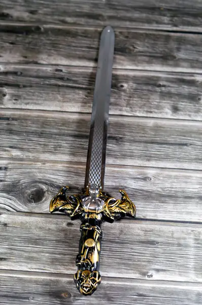 A plastic sword toy game for children, a sword is an edged, bladed weapon intended for manual cutting or thrusting. Its blade, longer than a knife or dagger, is attached to a hilt and can be straight