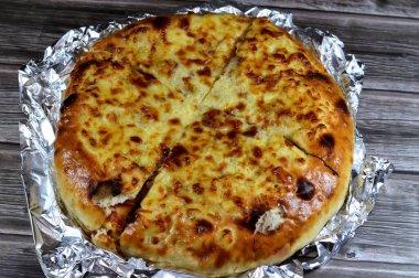 Çoklu katmanlı pizza keki, salam, barbekü tavuğu, peynir karışımı, sığır eti, sosis, mozarella peyniri, fırında pişirilmiş İtalyan pizzası, seçici odaklı bir pizza karışımı.