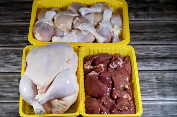 Fresh Raw chicken legs drumsticks hindquarter, raw full chicken with skin and bones and fresh uncooked chicken livers, gizzards and hearts, fresh liver, gizzard and heart of chickens full of protein