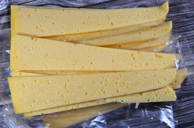 Slices of Egyptian Rumi cheese, also called gebna romiya or gebna turkiya, Roumi, Romi also Romy, middle Eastern parmesan hard cheese, has a pungent smell, and different degrees of saltiness