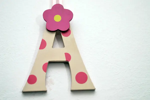 Letter A on the wall, the first letter and the first vowel letter of the Latin alphabet, used in the modern English alphabet, the alphabets of other western European languages and others worldwide