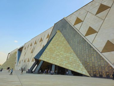 Giza, Egypt, April 13 2024: Exterior view of GEM The Grand Egyptian Museum, Giza Museum, Egypt's gift to the world, the largest archaeological museum in the world, near the Giza pyramid complex clipart