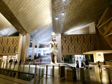 Giza, Egypt, April 13 2024: Monuments inside The Grand Egyptian Museum GEM, Giza Museum, Egypt's gift to the world, the largest archaeological museum in the world, near the Giza pyramid complex clipart