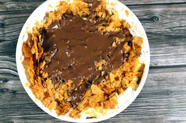chocolate paste sauce on top of Sweet Koshary recipe in Egypt made of multi layers of rice with milk sweet pudding, whipped cream, toasted Konafa and phyllo filo, with some other flavors and fillings clipart