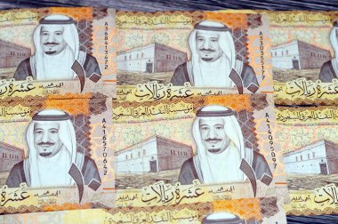 Saudi Arabia 10 SAR ten Saudi riyals cash money banknote with the photo of king Abdullah Bin AbdulAziz Al Saud, Murabba palace and King AbdulAziz Financial District in Al Aqeeq area of Riyadh clipart