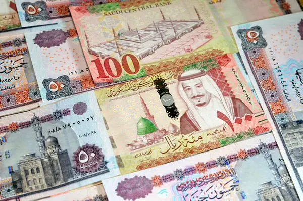 Stock image Saudi Arabia money banknotes bill of different value riyals of King Salman Bin AbdulAziz Al Saud era and Egyptian pounds notes, Saudi and Egypt money exchange rate and economy status, Pound and Riyal