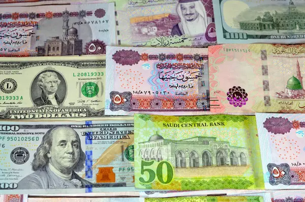 stock image USD American dollars cash, Saudi Arabia money banknotes bill of different value riyals of King Salman Bin AbdulAziz Al Saud era and Egyptian pounds notes, Saudi and Egypt money exchange rate