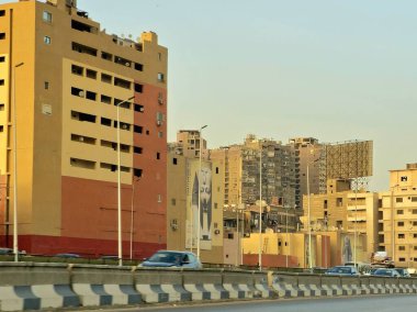 Giza, Mısır, 17 Mayıs 2024: Büyük Giza Mısır Müzesi yolundaki binaların dış görsel iyileştirmeleri, inşaat halindeki çevre yolundaki binaları boyamak ve geliştirmek