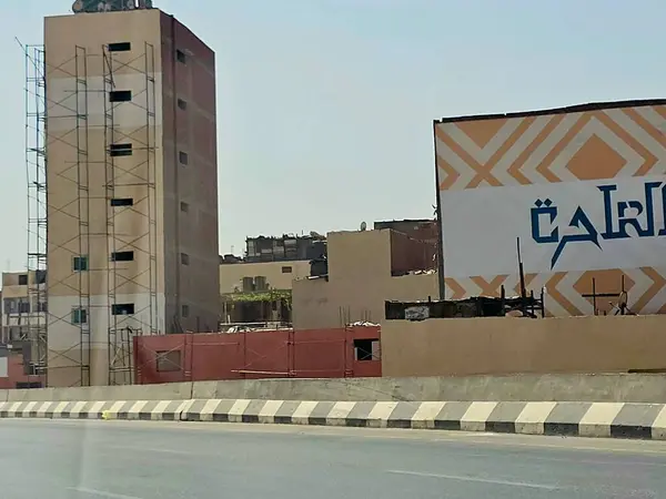 stock image Giza, Egypt, May 17 2024: External visual improvements of buildings on the ring road on the way of the Grand Giza Egyptian museum, painting and enhancing the buildings on ring road under construction