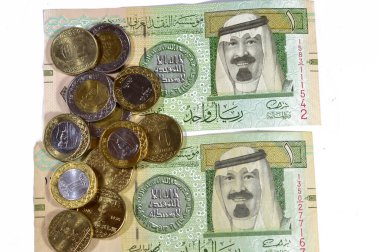 an old Saudi Arabia banknote bill, one 1 Riyal SAR features AbdullAllah bin Abdulaziz, Custodian of the Two Holy Mosques and the King of Saudi Arabia with Saudi riyals coins of 2, 1, half, quarter clipart