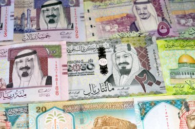 Saudi Arabia money banknotes of riyals bills, of different values features various kings of Saudi Arabia, money and economic status of the currency, inflation and growth concept clipart