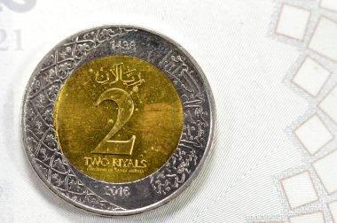 2 SAR two Saudi Arabian riyals coin, with Portrait of the founder of the dynasty of Al Saud, King AbdulAziz on obverse side and Multiple Coat of Arms within the Floral Ornamentation on reverse side clipart