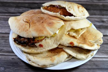 Traditional Egyptian popular breakfast street sandwiches of mashed fava beans, fried crispy falafel balls, fried aubergine in Shami Syrian bread and dynamite sandwich with a mix of all and eggs clipart