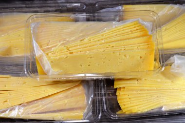 Slices of Egyptian Rumi cheese, also called gebna romiya or gebna turkiya, Roumi, Romi also Romy, middle Eastern parmesan hard cheese, has a pungent smell, and different degrees of saltiness clipart