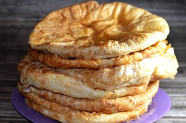 Egyptian Feteer meshaltet, layers upon layers of pastry dough with loads of ghee or butter in between, one of the famous Egyptian pastry recipes, a flaky Egyptian layered pastry bread dough and butter clipart