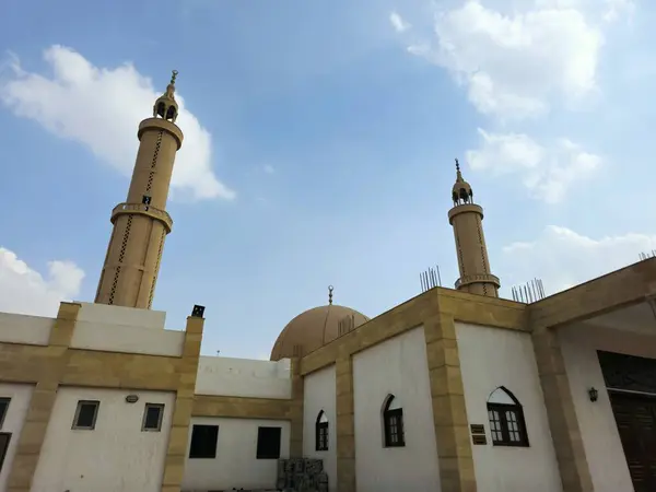 stock image The Exterior of a grand large mosque in Cairo against blue cloudy sky, a mosque masjid for the Islamic five prayers of the day, the place for worship and prayers for Muslims, selective focus