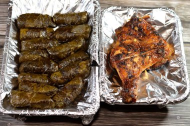 wrapped grape leaves stuffed Egyptian Mahshi and filled with white rice, onion, parsley, dill and coriander and Charcoal grilled barbecued chicken Arabian cuisine, recipe, moist and juicy barbecued clipart