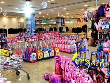 Giza, Egypt, September 16 2024: lots of backpacks school bags in a store, back to school and the school supplies, education and students concept, the bag is fabric sack carried on one's back clipart