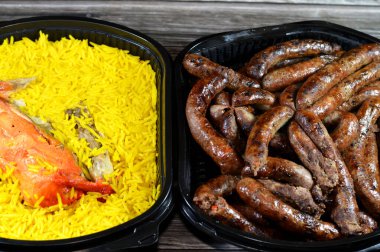 Background of grilled beef sausage, Egyptian sausages, spiced sausage either beef or lamb and Chicken mandi kabsa with long basmati rice, usually served with tomato dakos sauce, green salad and tahini clipart