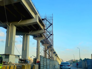 Cairo, Egypt, September 30 2024: A monorail structure site that is under construction with scaffoldings, Cairo monorail is a two-line mono rail rapid transit system currently under construction clipart