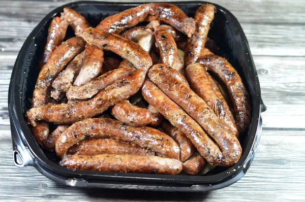 stock image Grilled Middle Eastern beef sausage, Egyptian sausages, it is a dry, spiced sausage either beef or lamb consumed in Middle East, barbecued meat sausages on a grill served in a disposable plate