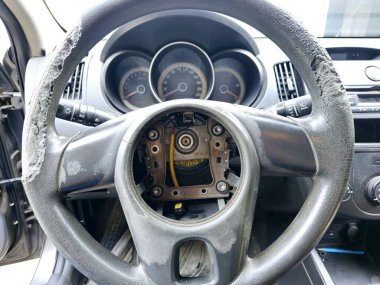 Replacement of airbag spiral cable clock spring with cracks of damaged rubber of the car steering wheel , the cable stores energy on a rotating axis, a spiral-wound special rotary electrical conductor clipart