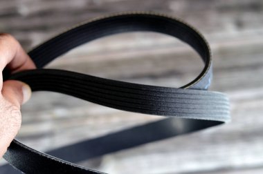 A ribbed belt v for automobiles, Ribbed Belt, a belt is a loop of flexible material used to link two or more rotating shafts mechanically, most often parallel. Belts may be used as a source of motion clipart