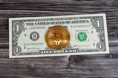 Bitcoin fiziksel altın sikke ile Amerikan dolar banknotu, BTC 1. Merkezi olmayan kripto para birimi, P2P bitcoin ağındaki düğümler işlemleri kriptografi ile doğruladı ve blockchain ile kaydedildi