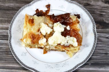 Kremalı qeshta ya da yastıklı turtada taze süt kreması ya da turta lapası gibi Feteer Meshaltet yastığı ince hamur ve ghee katmanlı ince katmanlı hamur ve hamur tatlısı, beyaz bal katmanlı