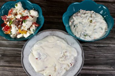 Creamy Cheese Spread with pastrami, Greek salad or horiatiki, made with pieces of tomatoes, cucumbers, onion, feta cheese, parsley and Roquefort Cheese salad with Creamy Cheese Spread, carrot, parsley clipart