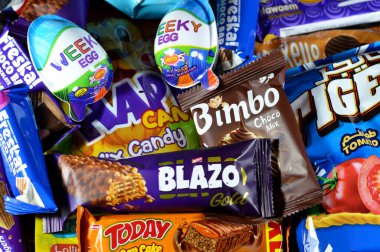 Kahire, Mısır, 29 Kasım 2024: Çeşitli çikolatalar, bisküviler, kekler, abur cuburlar ve patates cipsleri, Bimbo, Blazo, haftalık yumurta, kaplan patatesi, Freska çikolataları, Nawaem bisküvileri, bugün bar ve şeker karışımı