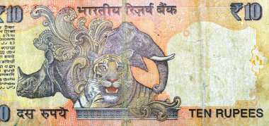 Hindistan Merkez Bankası tarafından yayınlanan 10 Hindistan Rupisi 'nin ters tarafının büyük bir bölümünde sol merkezde gergedan ve fil kafası, Hint para birimi ve ekonomi kavramı yer alıyor.