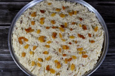 Basbosa tray with raisins or basbusa to be baked in the oven, Basbusa is a middle eastern dessert that is usually baked in Ramadan month, Arabian sweet cuisine background, selective focus clipart