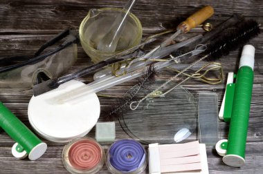 laboratory set of different equipment, safety goggles, Litmus papers to identify if the solution is an acid of Alkali, glassware test tube holders and cleaning brush, slides and other laboratory tools clipart