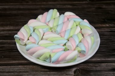 Marshmallows, marshmallow is a confectionery made from sugar, water and gelatin whipped to a solid-but-soft consistency, its naming comes from mallow plant species (Althaea officinalis), pile of candy