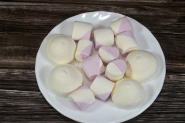 Marshmallows, marshmallow is a confectionery made from sugar, water and gelatin whipped to a solid-but-soft consistency, its naming comes from mallow plant species (Althaea officinalis), pile of candy
