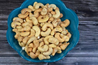 Salted and roasted Cashew nuts, Cashew is the common name of a tropical evergreen tree Anacardium occidentale, in the family Anacardiaceae. It is native to South America, the source of the cashew nut