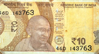 Hindistan Merkez Bankası tarafından yayınlanan on Hint Rupisi INR 'nin ters tarafının büyük bir kısmında, sol merkezde Mahatma Gandhi' nin bir portresi, sağ tarafta Teleskop seri numarası Ashoka Pillar yer alıyor.